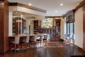 a bar in a library with chairs and a table at Residence Inn by Marriott Cincinnati Downtown/The Phelps in Cincinnati