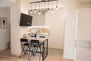 A television and/or entertainment centre at Top Center Designer Studio Apartment