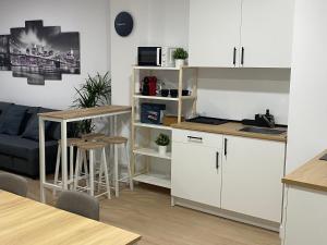 a kitchen and living room with white cabinets at Mateos in Murcia