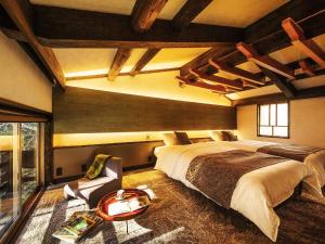 a large bedroom with a large bed and a table at Sumiya Rakusuitei - Vacation STAY 17241v in Takayama