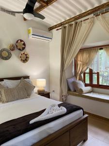 a bedroom with a large bed and a window at Casa Grimaldo in Valle de Anton