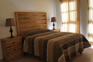 A bed or beds in a room at La Rosa House