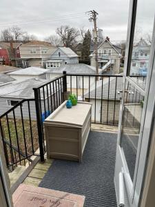 a view of a balcony with a bench on a porch at Sunny 2 BR Apartment west of Chicago in quaint Forest Park center in Forest Park