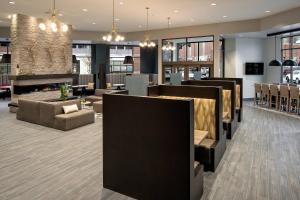 a lobby of a hotel with chairs and tables at Residence Inn by Marriott Boise Downtown City Center in Boise