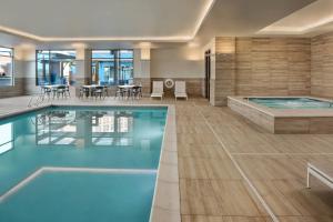 a hotel swimming pool with a table and chairs at Residence Inn by Marriott Boise Downtown City Center in Boise