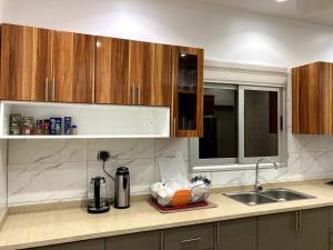 a kitchen with a sink and a counter top at Superbe mini-villa tout confort! in Ouagadougou