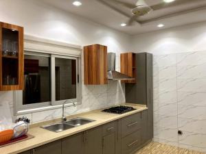 a kitchen with a sink and a stove in it at Superbe mini-villa tout confort! in Ouagadougou