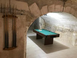 a room with a pool table in a castle at La Tranquillité proche Beauval et Châteaux de la Loire in Loches