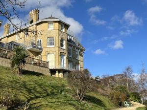 a large building on a hill with a blue sky at Sea View in Shanklin