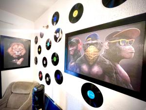 a wall with a bunch of records on it at A Casa que Hospeda in Sao Paulo