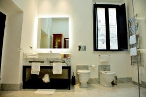 a bathroom with a sink and a toilet and a mirror at Palazzo Papa Gregorio XVI in Tivoli +54 photos