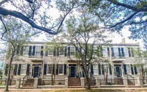 a large white house with blue doors and trees at Downtown Mobile, AL 2 Bedroom Townhome - Walk to Everything! in Mobile
