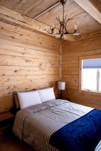 ein Schlafzimmer mit einem Bett in einem Blockhaus in der Unterkunft The Grafton Lodge in Grafton
