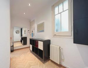 a living room with a television and a window at Stay U-nique Apartments Calabria in Barcelona