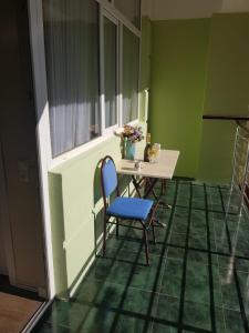 a table and chairs in a room with green walls at Seaside Apartments Batumi zurab gorgiladze street 96 2 th floor in Batumi