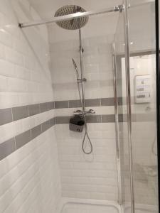 a shower with a glass door in a bathroom at Les Studios De Flo' : The Bel'Factory 38 m² WIFI in Belfort