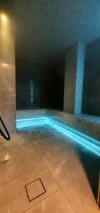 a swimming pool in a building with a blue poolvisor at Boutique Hotel Acacia in Lovran