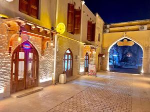 an empty street in an old building at night at Miniature Boutique Hotel in Bukhara