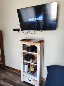 a flat screen tv on top of a tv stand at Casita de Piedra 10 in Trinidad