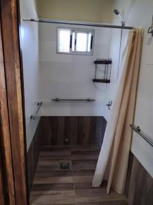 a bathroom with a shower and a shower curtain at Casita de Piedra 10 in Trinidad