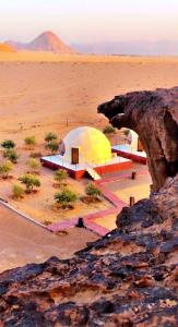 a group of tents in the middle of the desert at Adel rum camp bubbles in Wadi Rum