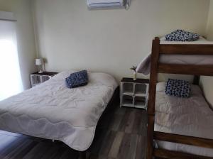 a bedroom with two beds and a bunk bed at Casita de Piedra 10 in Trinidad