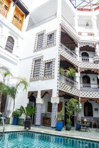 a building with a pool in front of it at Riad El Yacout in Fez