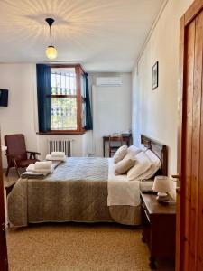 a bedroom with a large bed and a window at Foresteria Santa Maria di Betlem in Foligno