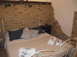 a bedroom with a bed with a brick wall at CASETTA_JOLANDA in Trapani