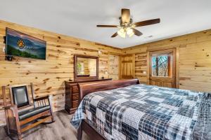 a bedroom with a bed and a ceiling fan at Paradise Found, Hot Tub, Mtn Views, Game Room, 560 FREE tickets each paid day! in Sevierville +69 photos
