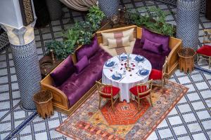 an overhead view of a living room with a table and chairs at Riad El Yacout in Fez