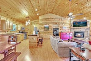a kitchen and living room in a log cabin at Paradise Found, Hot Tub, Mtn Views, Game Room, 560 FREE tickets each paid day! in Sevierville