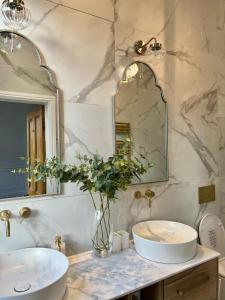 a bathroom with a sink and a mirror at Fayhomes West Midlands Luxury Late 1800 Property in Walsall