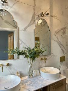 a bathroom with a sink and a mirror at Fayhomes West Midlands Luxury Late 1800 Property in Walsall +18 photos