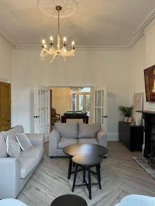a living room with a couch and a table at Fayhomes West Midlands Luxury Late 1800 Property in Walsall
