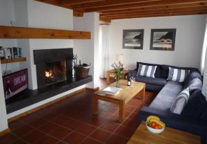 a living room with a couch and a fireplace at Waterville Holiday Homes No 10 in Waterville