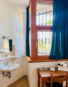 a bathroom with a sink and a window at Foresteria Santa Maria di Betlem in Foligno