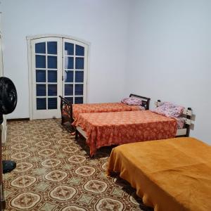 Ein Bett oder Betten in einem Zimmer der Unterkunft Casarão Hostel Peró