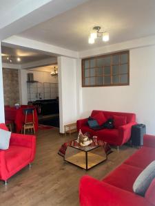 a living room with red couches and a table at PANORAMIC & AMAZING VIEWS Pvt apart close main square in Cusco
