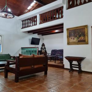 a living room with a couch and a table at Casarão Hostel Peró in Cabo Frio