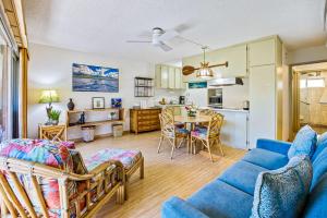 a living room with a blue couch and a table at Kihei Kai Oceanfront Condos in Kihei