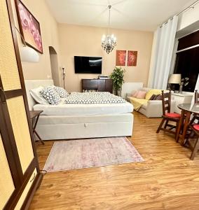 a bedroom with a bed and a living room at Home Away central apartment in Poprad