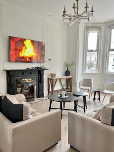 a living room with a fireplace and a fire place at Fayhomes West Midlands Luxury Late 1800 Property in Walsall