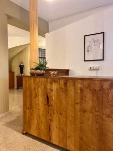 a lobby with a wooden counter in a building at Foresteria Santa Maria di Betlem in Foligno