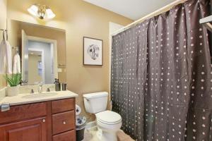 a bathroom with a toilet and a shower curtain at Splendid 4BR Apt close to Bars & Restaurants - Damen 1R in Chicago