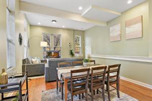 a dining room with a table and chairs and a couch at Splendid 4BR Apt close to Bars & Restaurants - Damen 1R in Chicago