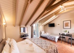 a bedroom with two beds and a television in it at Villa Verde in Lefkada Town