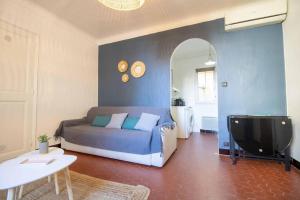 a bedroom with a bed and a tv in a room at SUITE CHARABOIS in Saint-Raphaël