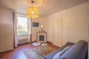 a living room with a couch and a table at SUITE CHARABOIS in Saint-Raphaël