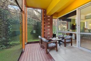 a patio with a table and chairs on a deck at Asteri Garden & Terrace Apartment in Sinaia